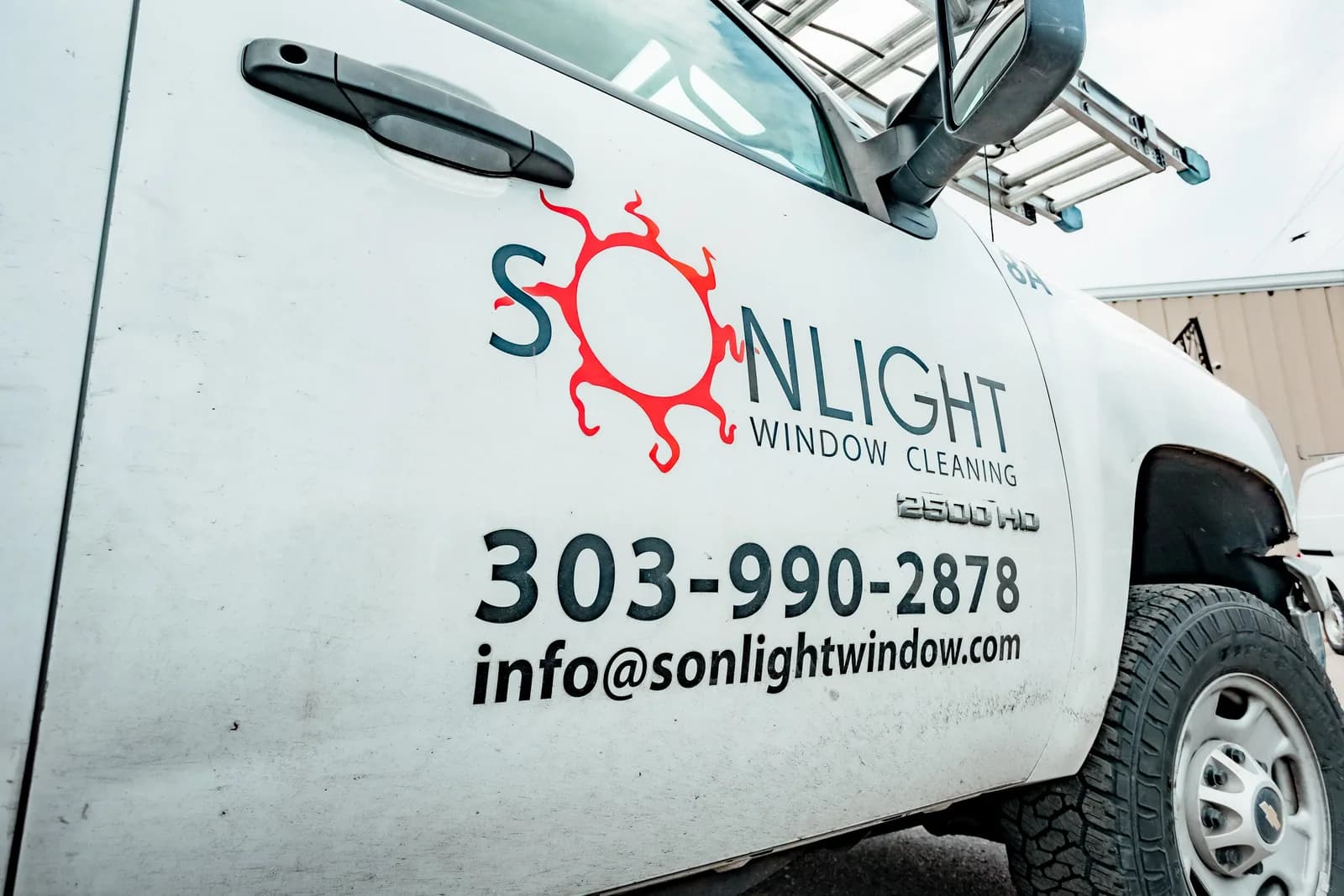 Sonlight Window Cleaning service truck with phone number 303-990-2878 — Louisville, Colorado