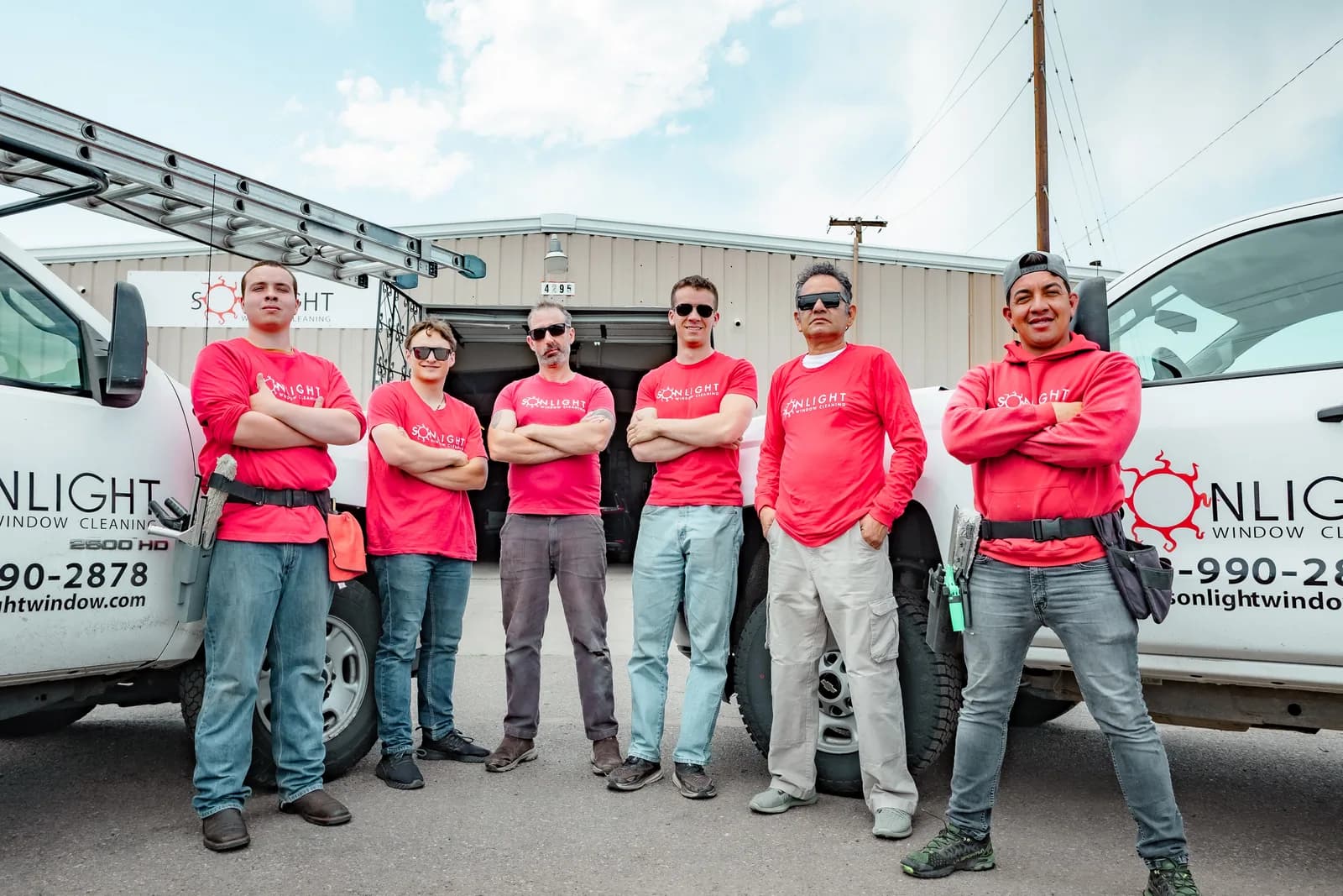 The Sonlight Window Cleaning crew posed in front of service trucks — Front Range Colorado