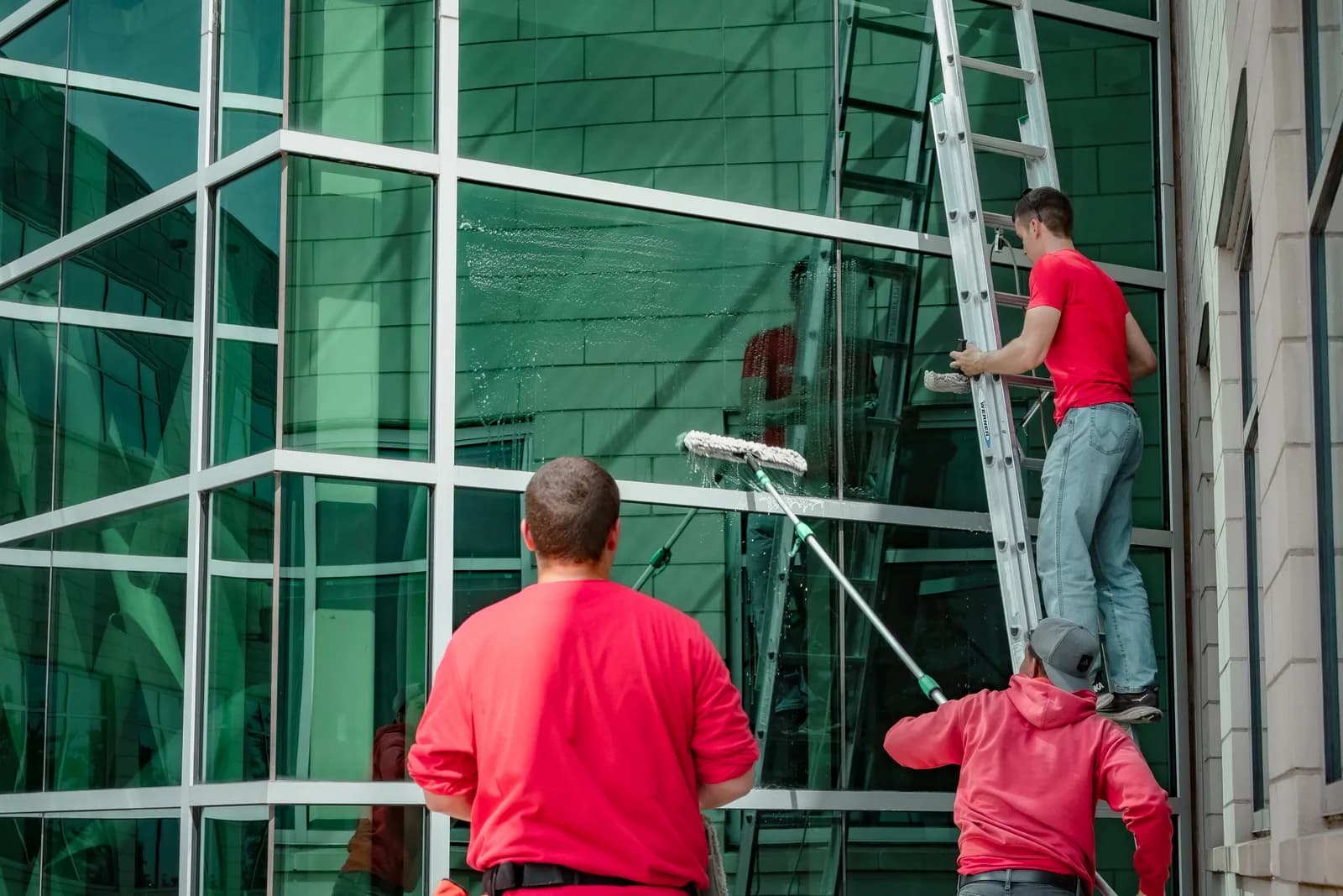 Sonlight team rinsing finished commercial glass on a Front Range building — Denver, Colorado