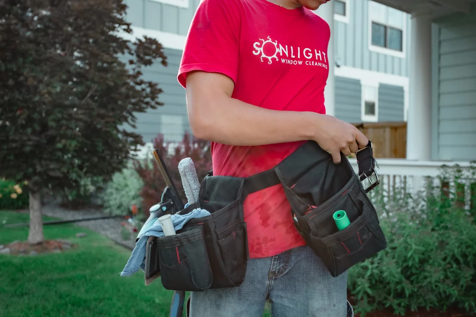 Sonlight technician with tool belt full of squeegees and brushes — Colorado Springs, Colorado