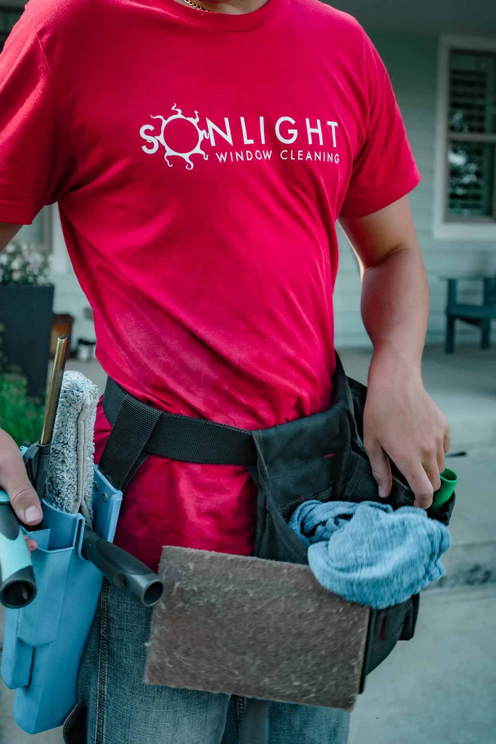 Closeup of a Sonlight Window Cleaning Colorado technician with branded uniform — Commerce City, Colorado